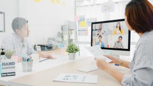 Asia businesspeople using desktop talk to colleagues discussing